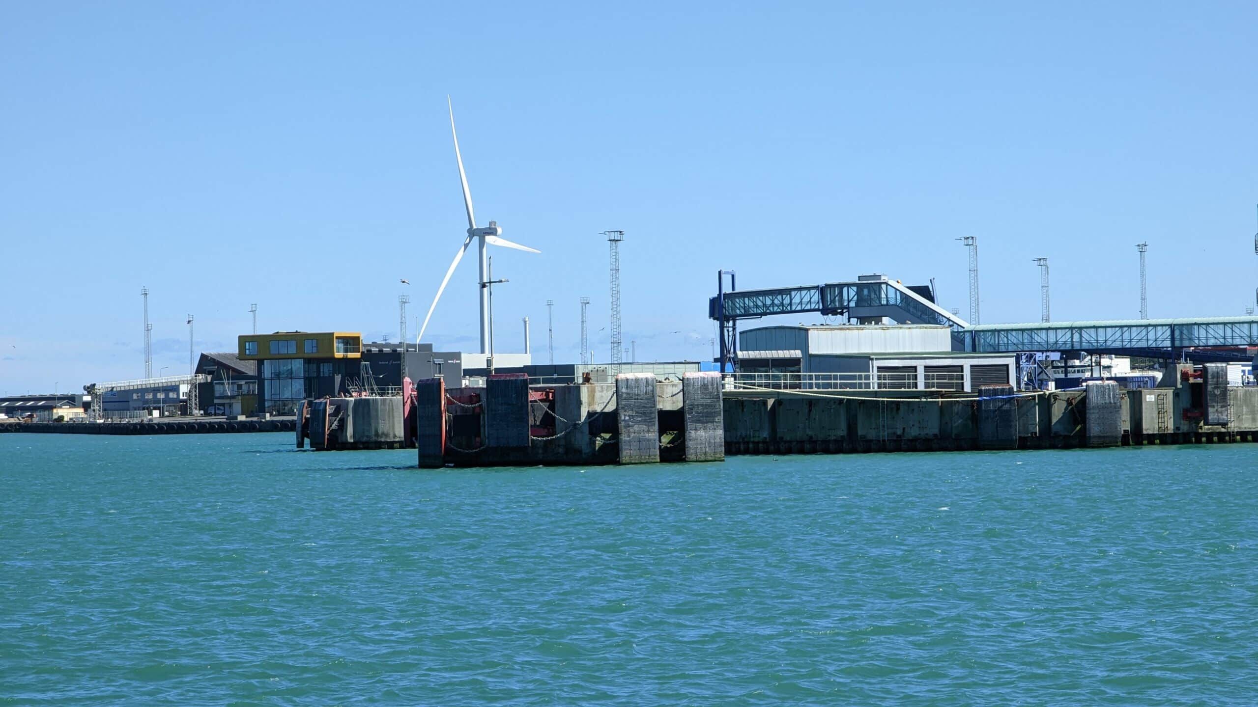 Ein Pier mit einer Windkraftanlage darauf.